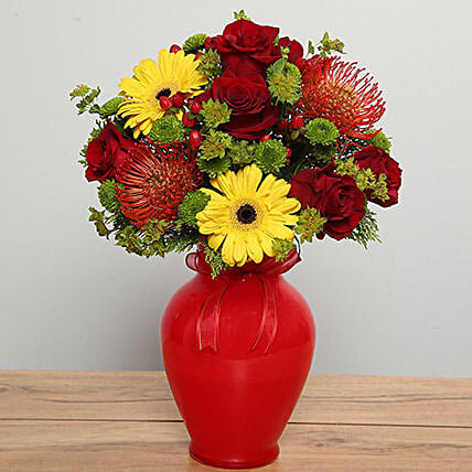 Mixed Flowers Arrangement In Red Glass Vase: 